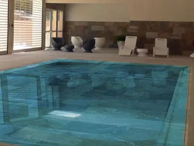 a large blue swimming pool in a room at Chalet 46m² avec Terrasse à Noves - API-1-52-531 in Noves