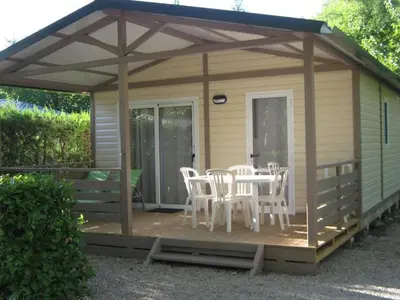 a gazebo with chairs and a table on a deck at Chalet confort avec terrasse - 5 personnes - API-1-52-621 in Noves