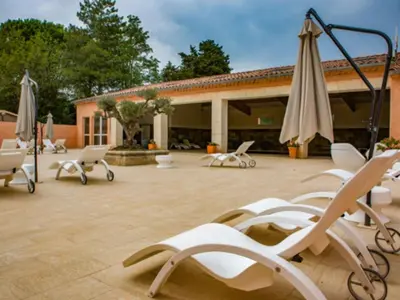 a group of chairs and umbrellas on a patio at Chalet confort avec terrasse - 5 personnes - API-1-52-621 in Noves