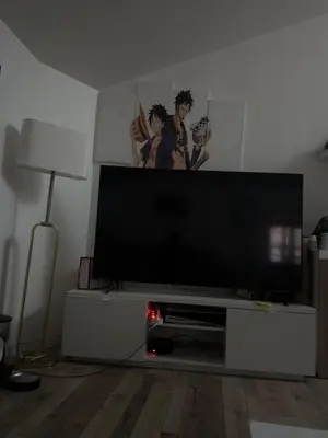 a living room with a large flat screen tv at Apparemment t3 in Noves