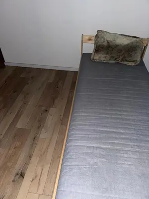 a bed with a pillow sitting on top of a floor at Apparemment t3 in Noves