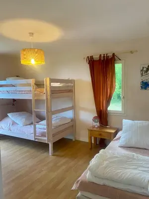 a bedroom with two bunk beds and a window at Le Pré de la Reyne in Sault-de-Vaucluse