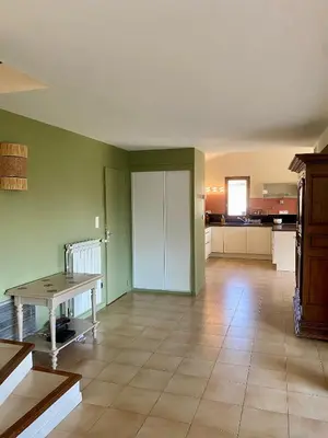 a large room with a table and a kitchen at Le Pré de la Reyne in Sault-de-Vaucluse