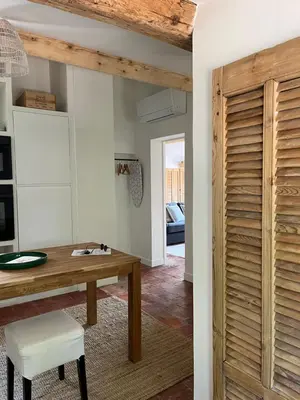 a room with a table and a wooden door at Appartement cocooning centre ville in Aix-en-Provence
