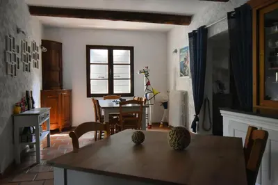 a kitchen with a table and a dining room at Les Chambres du Luberon & Table d'hôtes in Lauris