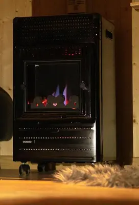 a black oven with a fire in it at Homnest - Infusion Provençale - Lisière & Ocres in Viens