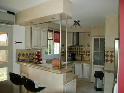 a kitchen with white cabinets and a counter top at Villa in Reillanne with Private Pool in Reillanne