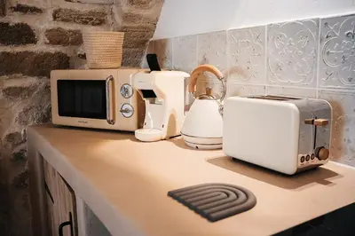 a kitchen counter with a toaster toaster and a toaster at Évasion grecque en duo Suite balnéo Wifi in Carpentras