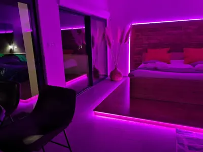 a bedroom with a bed with purple lights in it at Cocon D'amour En Luberon - Chambre Spa a proximite de l'Isle sur la Sorgue in LʼIsle-sur-la-Sorgue