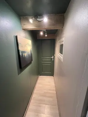 a hallway with a green door and a tile floor at Petite maison avec piscine le chêne vert in Gargas