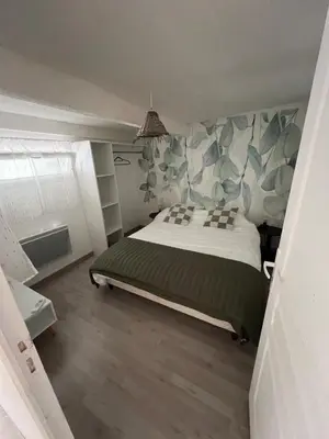 a bedroom with a large bed in a room at Petite maison avec piscine le chêne vert in Gargas