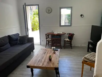 a living room with a couch and a coffee table at Au pied du Colorado Provencal in Rustrel