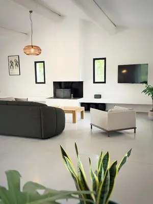 a living room with a couch and a table at Villa des Glauges in Eyguières