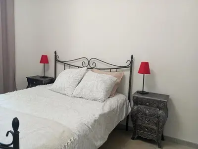 a bedroom with a bed and two lamps on tables at Evasion Aixoise logement T2 au Centre historique in Aix-en-Provence