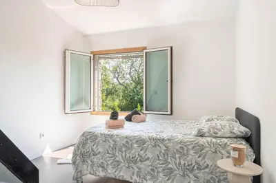 a bedroom with a bed with two stuffed animals on it at Villa le Trèfle with pool in Velaux