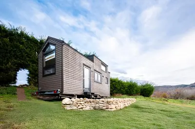 a tiny house sitting on top of a lush green field at Domaine Paradis in Reillanne