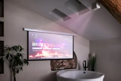a large screen television in a bathroom with a tub at Domaine Paradis in Reillanne