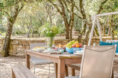 a wooden table with a bowl of fruit on it at La Mathilde - Premium Pool Villa Private Tree-Top Adventure in Bonnieux