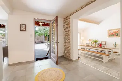 an open living room with a table and a door at La Mathilde - Premium Pool Villa Private Tree-Top Adventure in Bonnieux