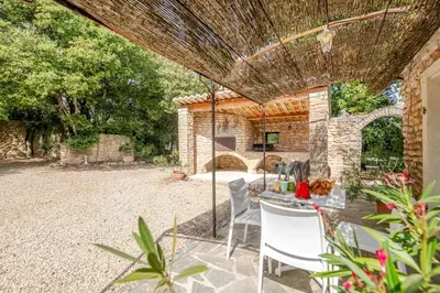 an outdoor patio with a table and chairs at La Mathilde - Premium Pool Villa Private Tree-Top Adventure in Bonnieux