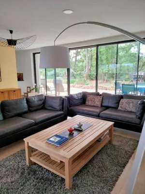 a living room with a couch and a coffee table at Contemporary Villa With Pool In Céreste-En-Luberon in Céreste