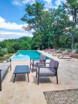 a patio with lounge chairs and a swimming pool at Contemporary Villa With Pool In Céreste-En-Luberon in Céreste