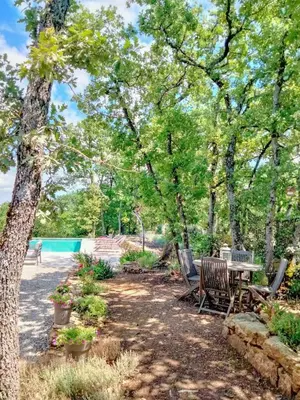 a picnic table and chairs in a park with trees at Contemporary Villa With Pool In Céreste-En-Luberon in Céreste