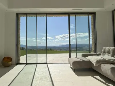 a kitchen and dining room with a table and chairs at Villa With Panoramic Views And Pool In Gordes in Gordes