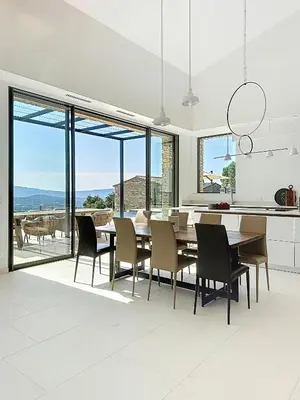 a kitchen and dining room with a table and chairs at Villa With Panoramic Views And Pool In Gordes in Gordes