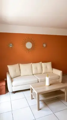 a living room with a couch and a table at Duplex en centre ville avec un Garage privé in Salon-de-Provence