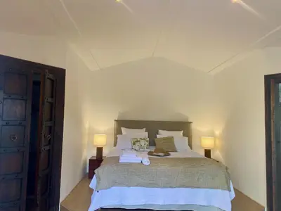a bedroom with a large bed with two lamps at Mas de la Calade Bed & Breakfast in Aix-en-Provence