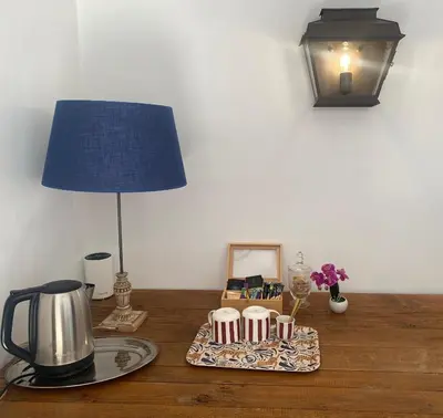 a table with a lamp and a tea kettle on it at Mas de la Calade Bed & Breakfast in Aix-en-Provence