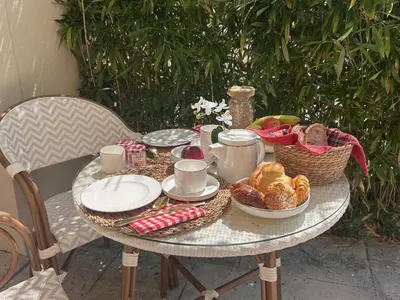 a table with a breakfast of bread and pastries on it at Mas de la Calade Bed & Breakfast in Aix-en-Provence