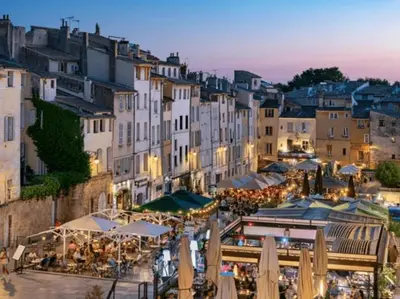 a view of a town with tables and umbrellas at Studio climatisé avec terrasse, 5ème étage sans ascenseur in Aix-en-Provence