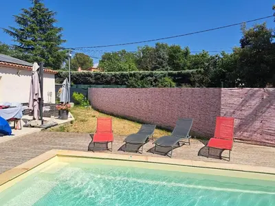 a group of chairs sitting next to a swimming pool at Villa Eguilles, ensoleillée, piscine à 10 mn d' Aix en Provence in Éguilles