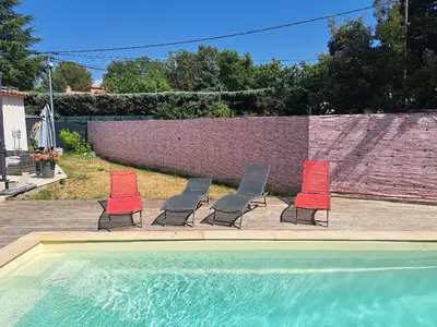 a group of four chairs and a swimming pool at Villa Eguilles, ensoleillée, piscine à 10 mn d' Aix en Provence in Éguilles