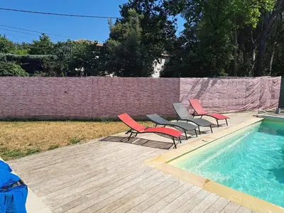 a group of chairs sitting next to a swimming pool at Villa Eguilles, ensoleillée, piscine à 10 mn d' Aix en Provence in Éguilles
