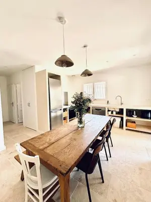 a large kitchen with a wooden table and chairs at Maison Poumo, Piscine, clim & padel privé,12 pers in LʼIsle-sur-la-Sorgue