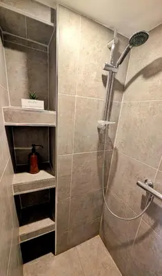 a bathroom with a shower with a glass door at Cosy & Cocooning in Le Thor