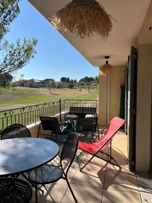 a group of tables and chairs on a patio at Golf apartment in Saumane-de-Vaucluse