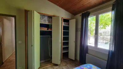 a room with a room with a window and a closet at Gîte Le Verger Paisible in Malemort-du-Comtat
