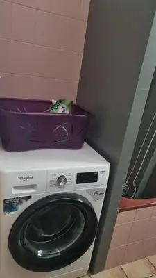 a washing machine with a basket on top of it at Gîte Le Verger Paisible in Malemort-du-Comtat