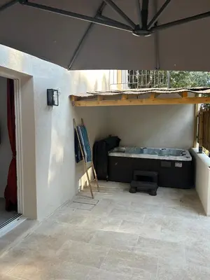a room with a table and a painting on the wall at Suite jacuzzi in Aix-en-Provence