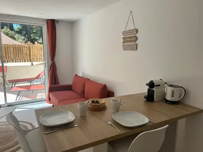 a kitchen with a table with plates on top of it at Suite jacuzzi in Aix-en-Provence