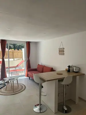 a living room with a table and a couch at Suite jacuzzi in Aix-en-Provence