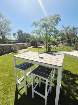 a picnic table and two chairs sitting on a lawn at Ô nuits de saint cannat in Saint-Cannat