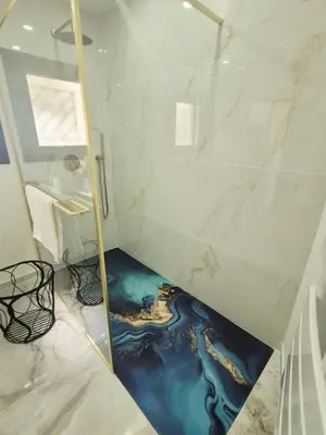 a bathroom with a painting of a river on the floor at Ô nuits de saint cannat in Saint-Cannat