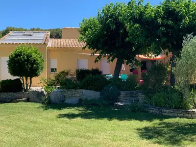 a house with a yard in front of it at La bergerie in Cadenet