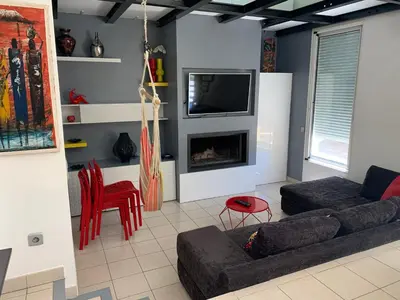 a living room with a couch and a tv at La bergerie in Cadenet