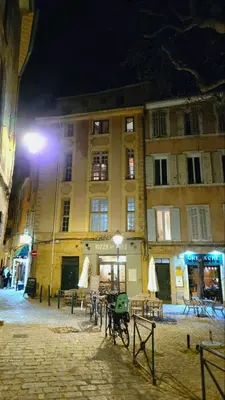 a city street with a clock tower and a building at Appartement cosy et silencieux avec salon & chambre & mezzanine - 3 couchages - en plein centre historique et proche transports in Aix-en-Provence